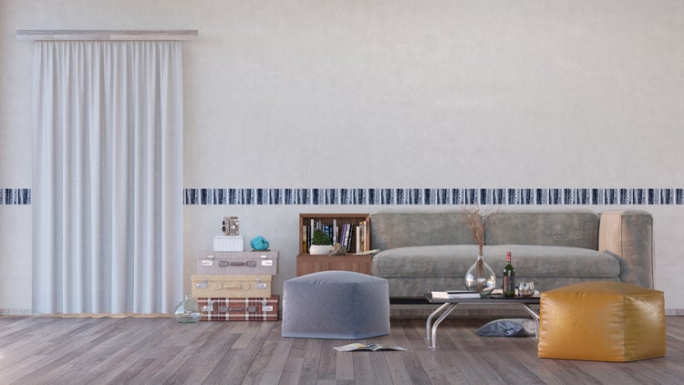 Wohnzimmer mit Couch, Tisch, Bücherregal, Dekoration und Bordüre an der Wand