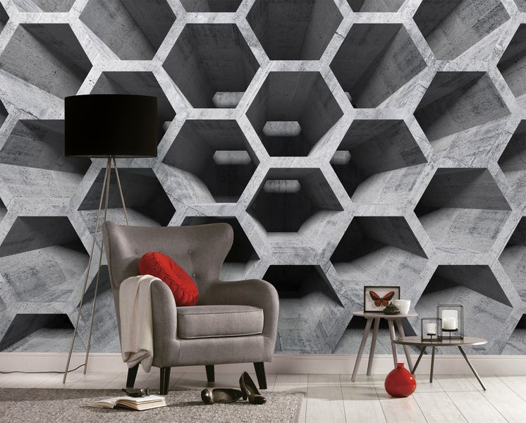 Modernes Wohnzimmer mit 3D-Fototapete in Betonoptik mit Wabenmuster, grauem Sessel und schwarzer Stehlampe.