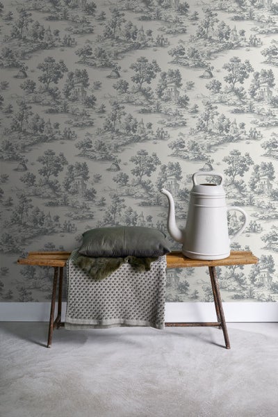 Tapete mit Landschaftsmuster hinter Bank mit Gießkanne und Kissen