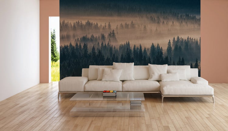 Fototapete mit Nebelwald in einem modernen Wohnzimmer mit hellem Ecksofa, Glastisch und Parkettboden.