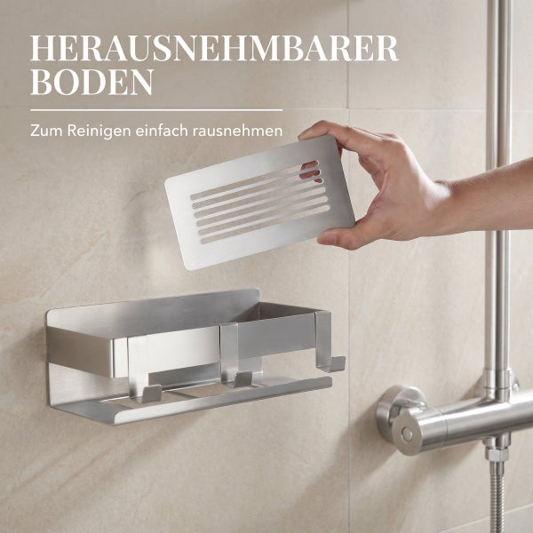 Duschablage aus Edelstahl mit herausnehmbarem Boden zur einfachen Reinigung, montiert an einer Duschwand.