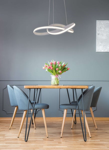 Esstisch mit Stühlen und moderner LED-Hängeleuchte über dem Tisch