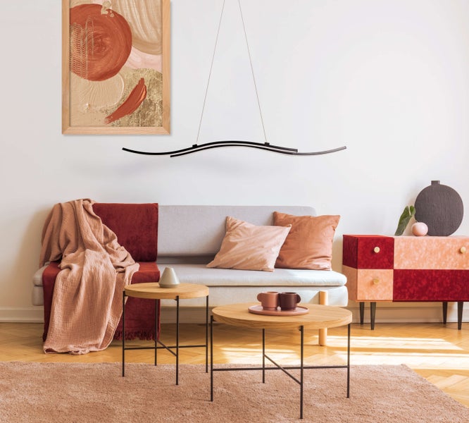 Wohnzimmer mit Sofa, Couchtisch, Kommode und abstrakter Kunst an der Wand