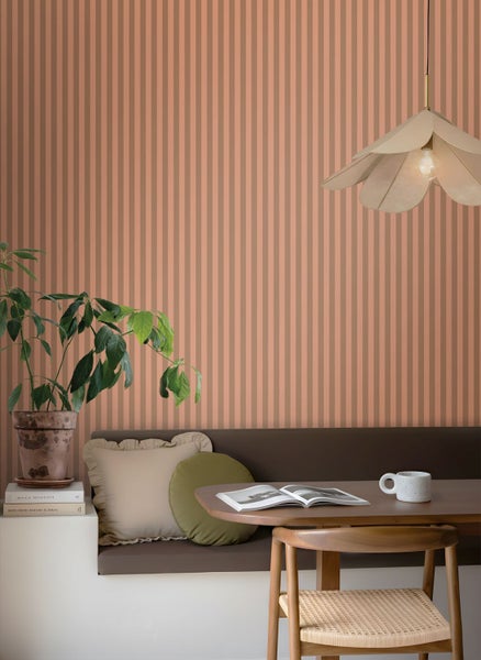 Zimmer mit gestreifter Tapete, Sitzbank, Tisch und Lampe