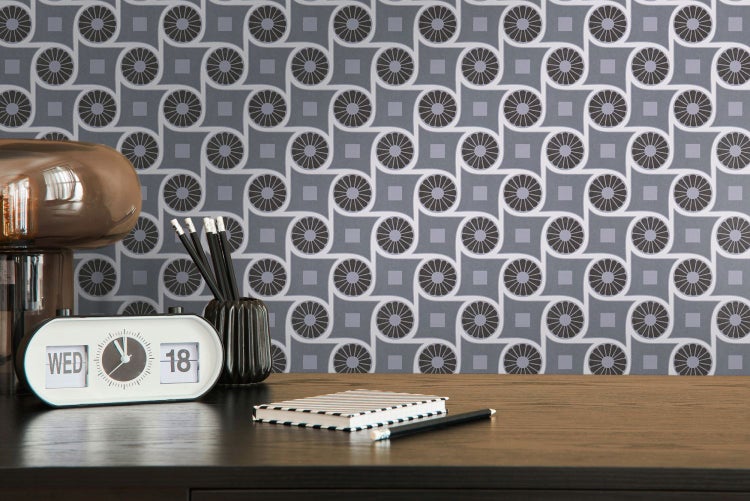 Dekorative Tapete mit geometrischem Muster hinter einer Kommode