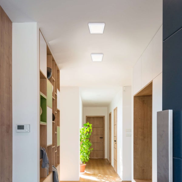 Flur mit eingebauten Regalen, Schränken und zwei quadratischen Deckenleuchten