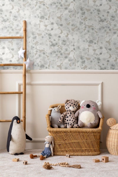 Tapetenbordüre mit Vogel- und Pflanzenmotiv in einem hellen Wohnzimmer mit beigem Sofa, runden Holztischen und einem flauschigen Teppich.