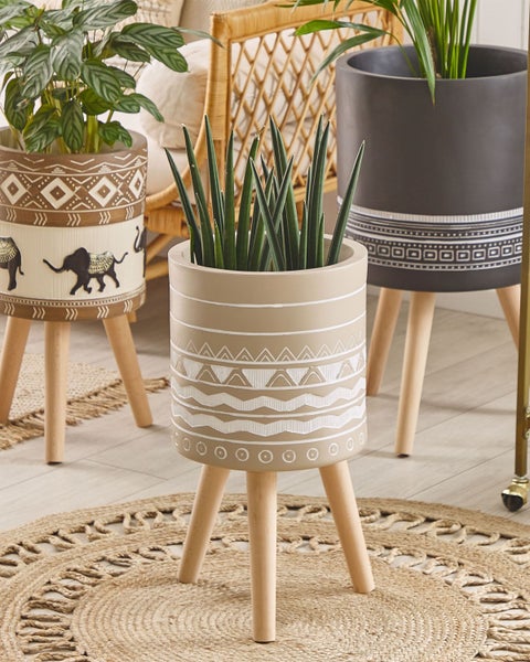 Dekorative Blumentöpfe auf Holzbeinen mit geometrischen Mustern