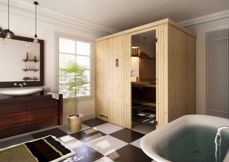 Helle Sauna aus Holz mit Glastür in einem geräumigen Badezimmer mit Badewanne, dunklem Waschtisch und schwarz-weißem Fliesenboden.