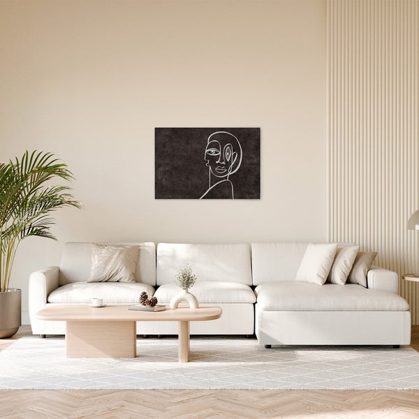 Dekoratives Wandbild mit abstrakter, weißer Linienkunst in einem Wohnzimmer.