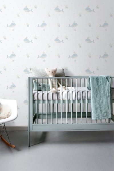 Kinderzimmer mit Babybett und Wal-Tapete