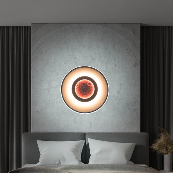 Schlafzimmer mit rundlicher Wandleuchte über dem Bett