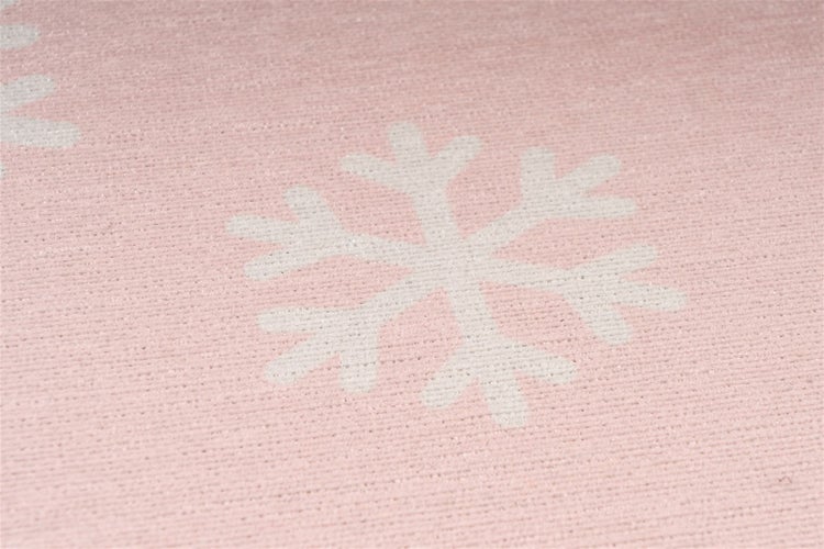 Nahaufnahme eines gewebten Textils mit Schneeflockenmuster.