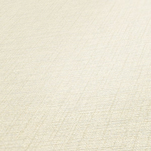 Helles Schlafzimmer mit Holzbett, Zimmerpflanze und Strohhut für eine freundliche Atmosphäre