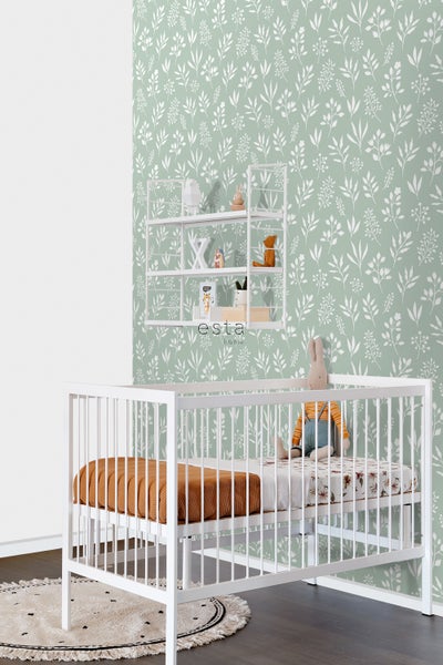 Kinderzimmer mit weißem Gitterbett, Wandregal und floraler Tapete