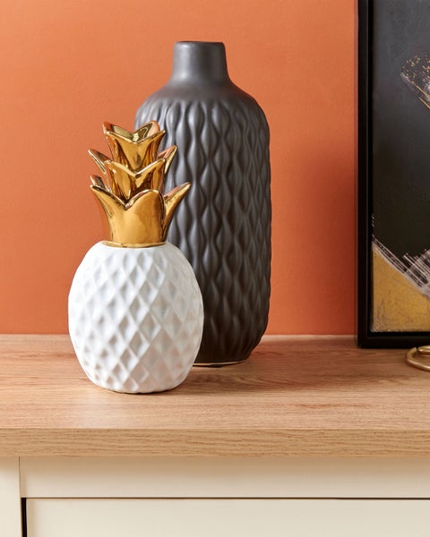 Dekorative Ananas und Vase auf einem Tisch