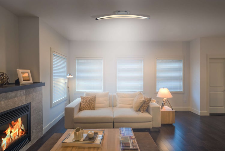 Helles Wohnzimmer mit Sofa, Kamin und moderner Deckenleuchte