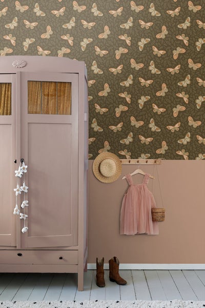 Einrichtungsidee mit Kleiderschrank, Wand mit Tapete mit Schmetterlingsmuster, Kleiderhakenleiste mit Kleid und Accessoires.
