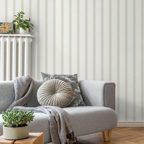 Wohnzimmer mit gestreifter Tapete, Sofa und dekorativen Elementen für eine gemütliche Atmosphäre