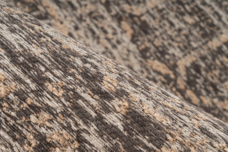 Nahaufnahme einer gewebten Teppichstruktur mit abstraktem Muster und gerippter Oberfläche.