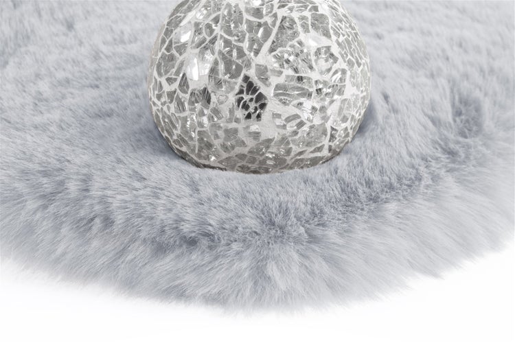 Mosaik-Leuchte aus Glas auf einem Kunstfell-Teppich.