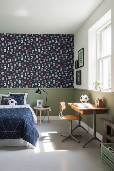 Jugendzimmer mit Bett, Schreibtisch und nummerierter Tapete