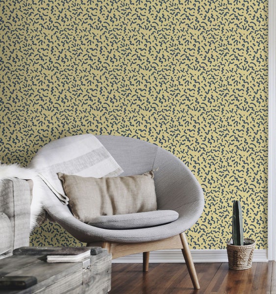 Wohnzimmer mit gemusterter Tapete, Sessel und Dekoration