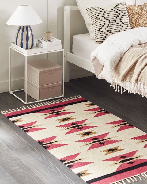 Flachgewebter Teppich mit geometrischem Muster in Pink, Schwarz und Beige im Ethno-Stil und Fransen.