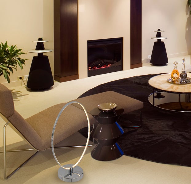 Wohnzimmer mit Kamin, Lautsprechern, Liege, Beistelltisch und LED-Stehlampe