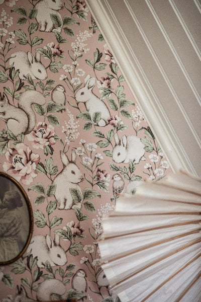 Kinderzimmer mit Tiermotivtapete, Babybett und Kommode