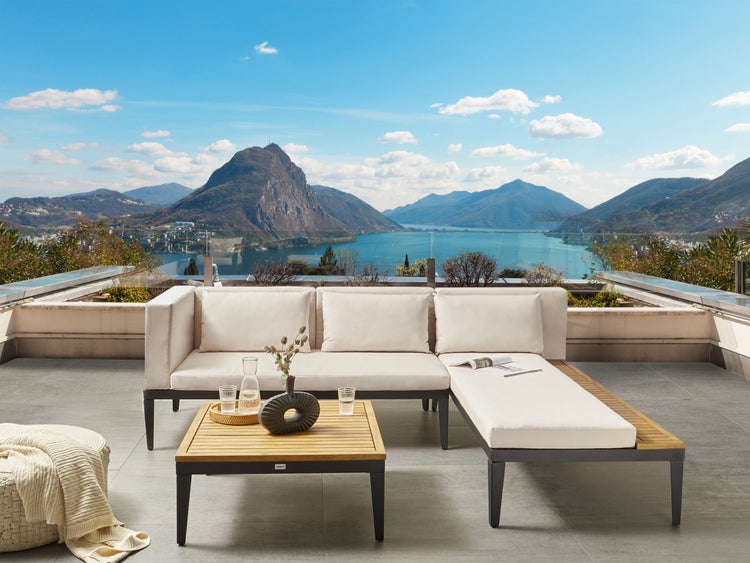 Outdoor Lounge Set mit Tisch und Hocker auf einer Terrasse mit Seeblick