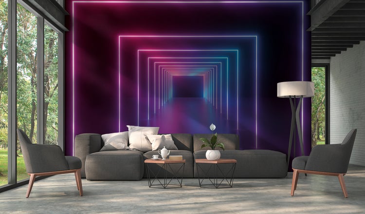 Fototapete mit einem dreidimensionalen Neon-Tunnel in einem modern gestalteten Wohnzimmer mit grauem Sofa und Sesseln.