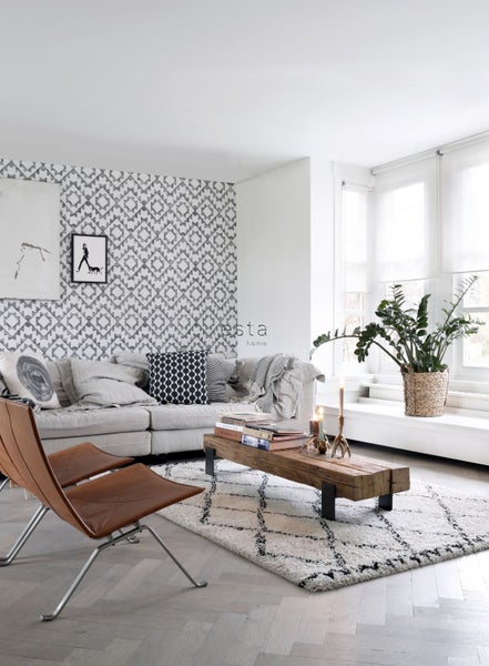 Wohnzimmer mit Sofa, Teppich, Couchtisch und Dekorationen für eine gemütliche Atmosphäre