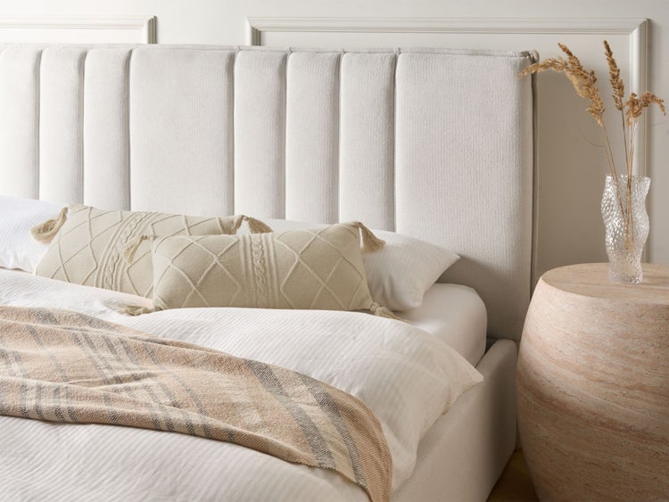 Bett mit gestepptem Kopfteil, Kissen und Beistelltisch