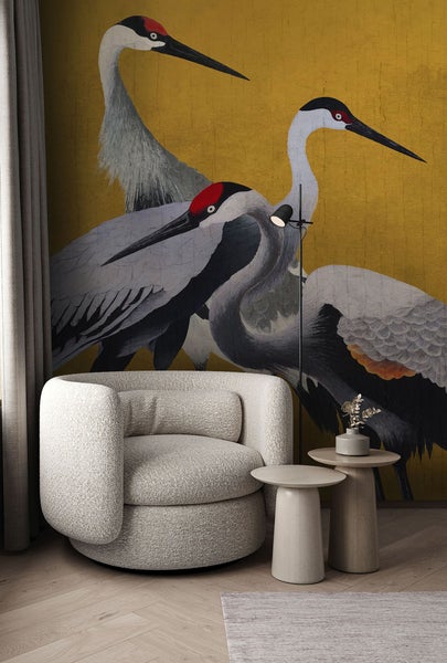 Wohnzimmer-Szene mit Sessel, Beistelltischen und Tapete mit Kranichmotiven