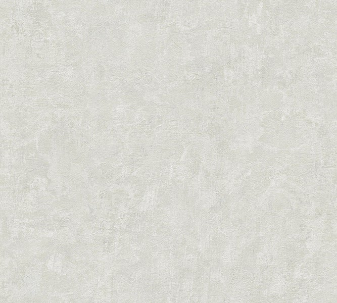 Innenraum mit Stuhl, Korb und dekorativem Zweig vor einer dezent gemusterten Wand