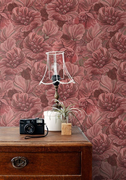 Raumansicht mit geblümter Tapete, Lampe, Kommode und Dekoration