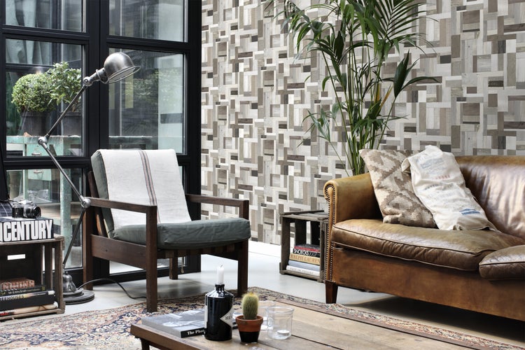 Wohnzimmer mit Sofa, Sessel, Stehlampe, Teppich und dekorativer Wandgestaltung