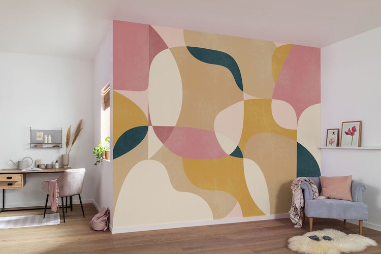 Heller Raum mit grafischer Tapete, Schreibtisch und Sessel