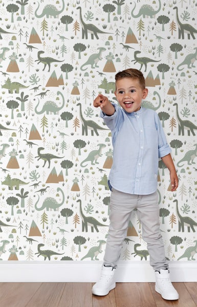 Junge vor einer Dinosaurier Tapete mit Baum und Berg Motiven