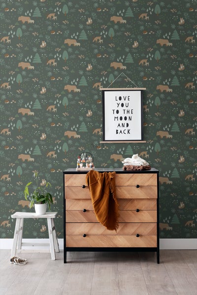 Raumszene mit einer Kommode vor einer Tapete mit Waldtiermotiv und einem gerahmten Kunstdruck darüber.