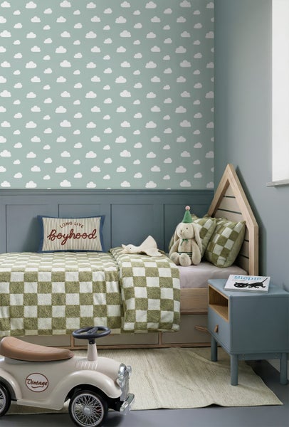 Kinderzimmer mit Wolkentapete, Hausbett aus Holz mit karierter Bettwäsche, Nachtisch und Vintage-Tretauto.