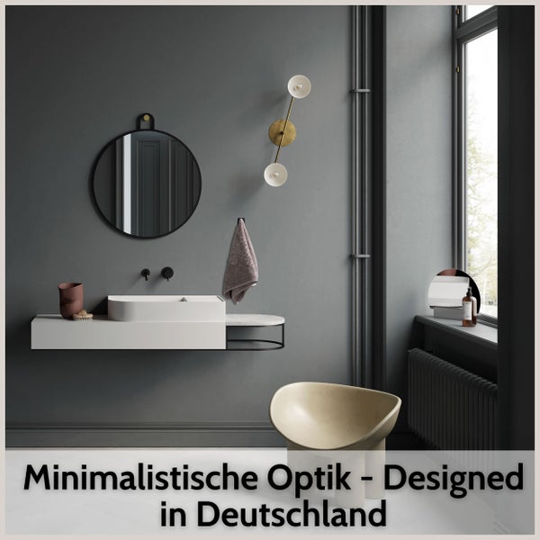 Modernes Badezimmer mit minimalistischem Aufsatzwaschbecken, rundem Spiegel und Wandleuchte.