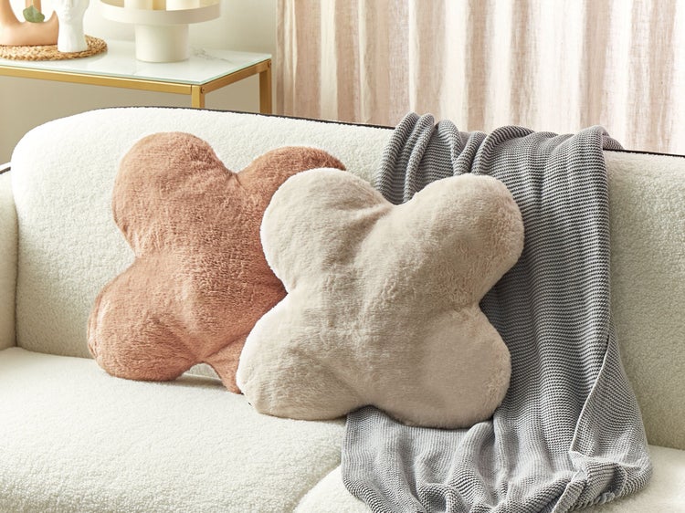 Dekorative, kreuzförmige Kissen auf einem Sofa