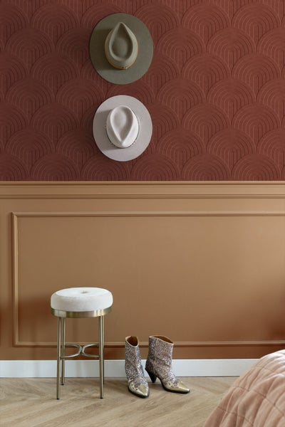 Zimmeransicht mit dekorativer Wandgestaltung, Hocker und Stiefeln