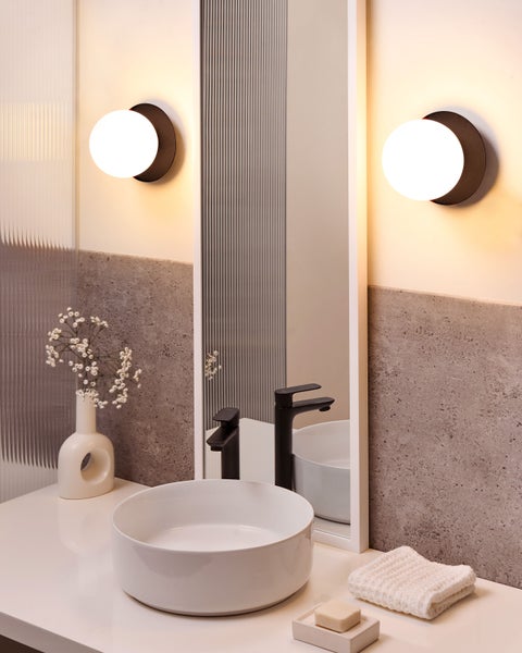 Modernes Badezimmerdesign mit Aufsatzwaschbecken, Spiegel und Wandleuchten