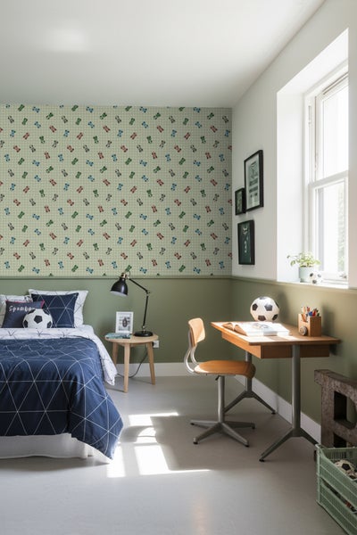 Jugendzimmer mit Bett, Schreibtisch und mit Automotiven gemusterter Tapete