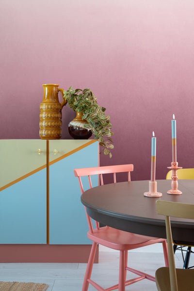 Esszimmer mit Tisch, Stühlen, Kommode und dekorativen Vasen