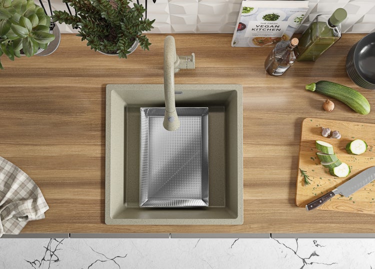 Spüle mit Abtropfschale, Armatur, Schneidebrett und Kochbuch auf einer Küchentheke