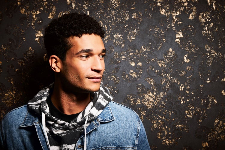 Porträt eines Mannes vor einer gemusterten Wand